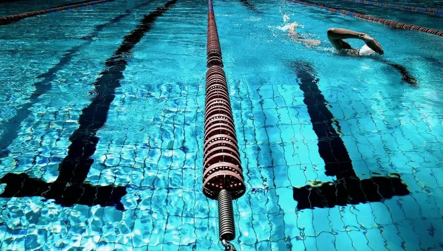 Lane ropes and a swimmer seen from under the water