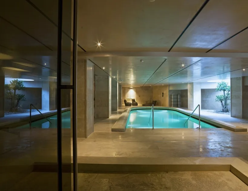 A quiet indoor pool seen through a glass door